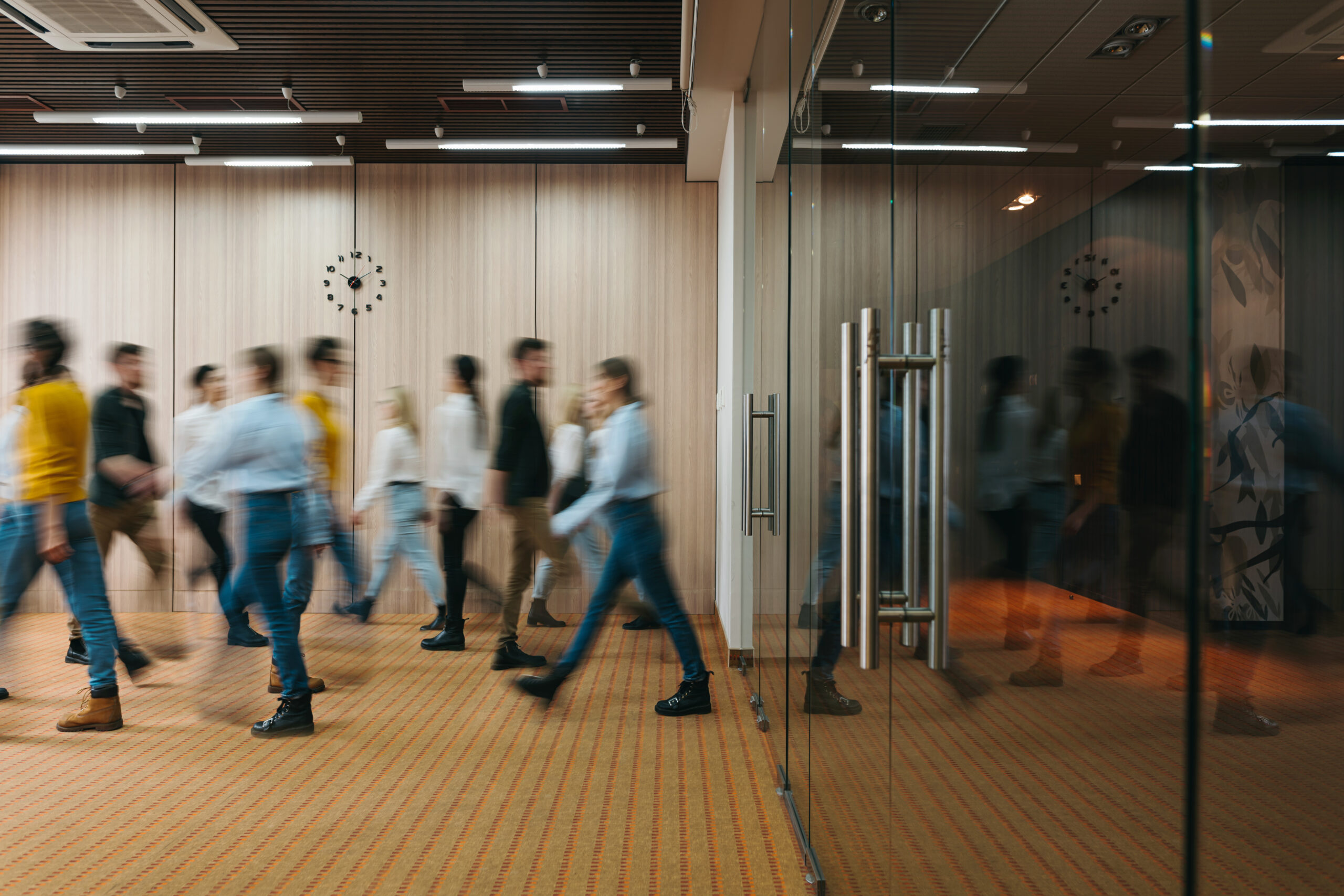 Group of office employees at coworking hall. Business people walking at modern open space. Motion blur. Concept; Shutterstock ID 1731858418; Project Name : Client practices playbook; Department : Brand design; Name: Emma Irvine; Date: 17/02/2021