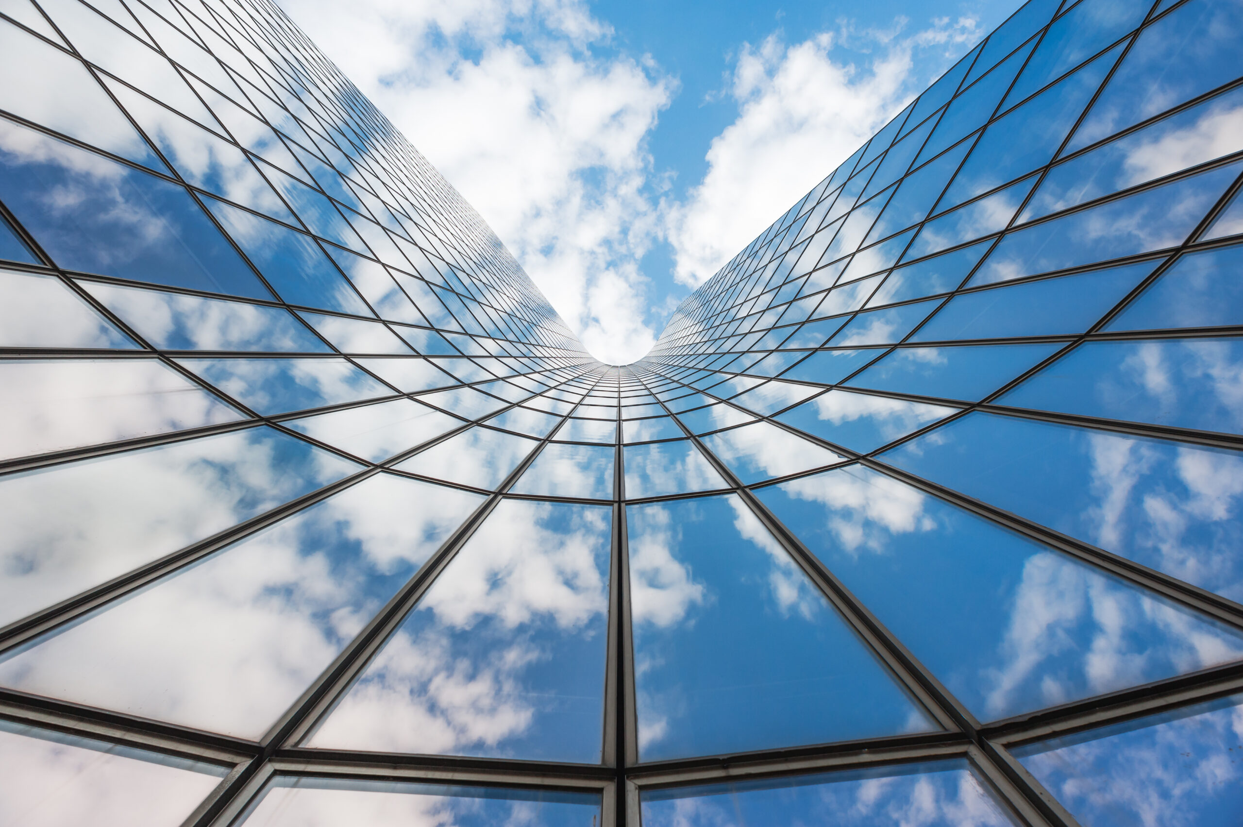 Blue,Sky,And,White,Clouds,Reflecting,In,A,Glass,Building