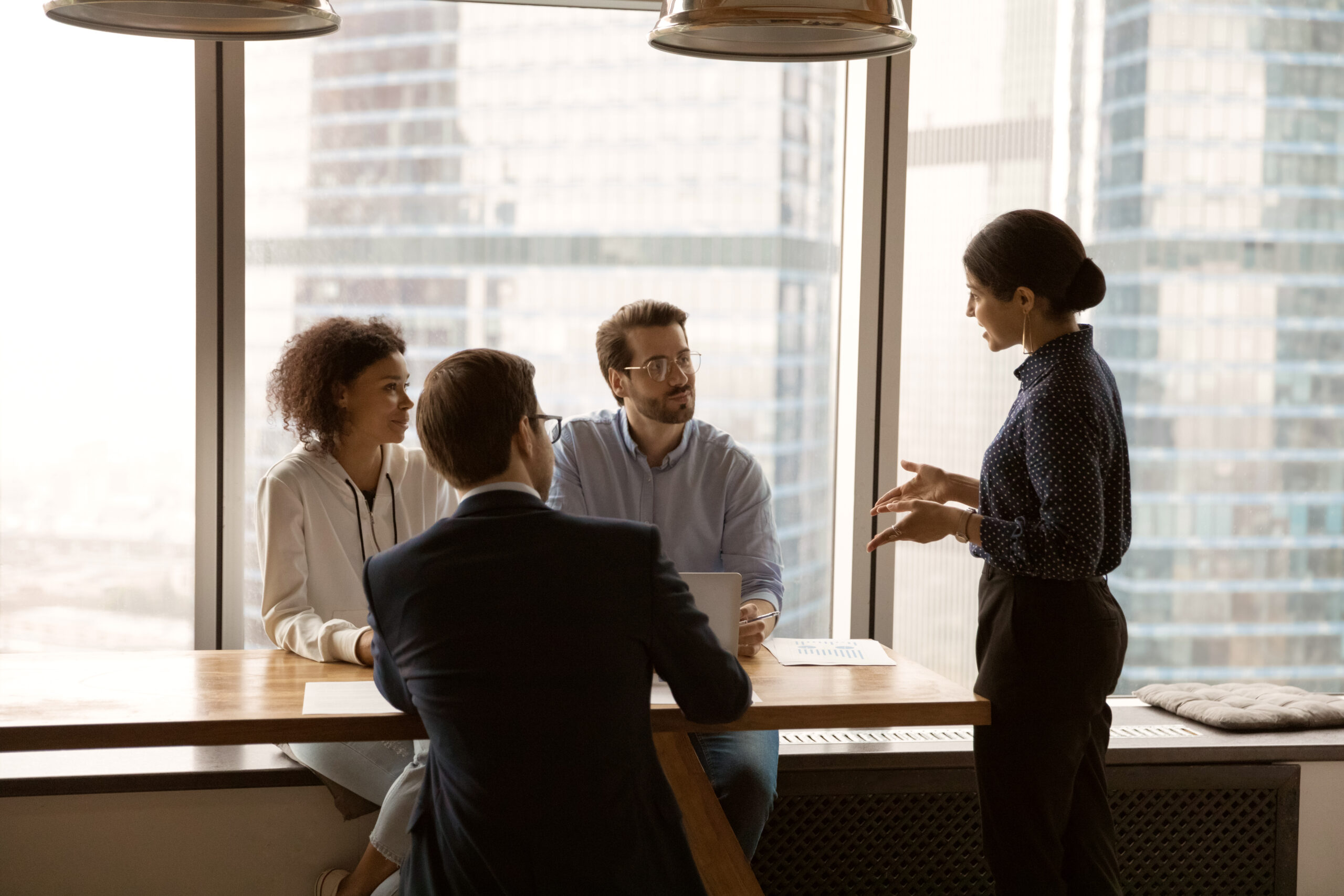 Confident indian female business coach provide professional training to multiethnic corporate staff. Young hindu woman team leader explain sales strategy to attentive employees on briefing in office; Shutterstock ID 1911368224; Project_Name: Life sciences - refresh; Department : Life sciences; Name: Lindsay Iddon; Date: 29/11/22